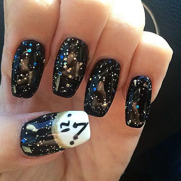Photo of black nails with clock accent and glitter