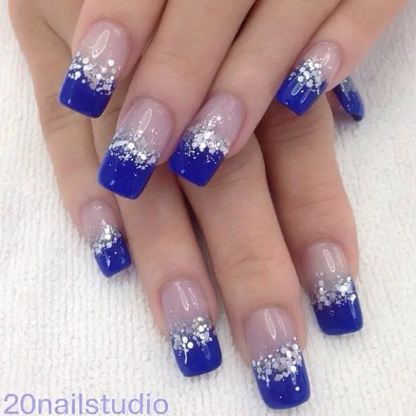 Photo of blue french tip nails with silver gltiter