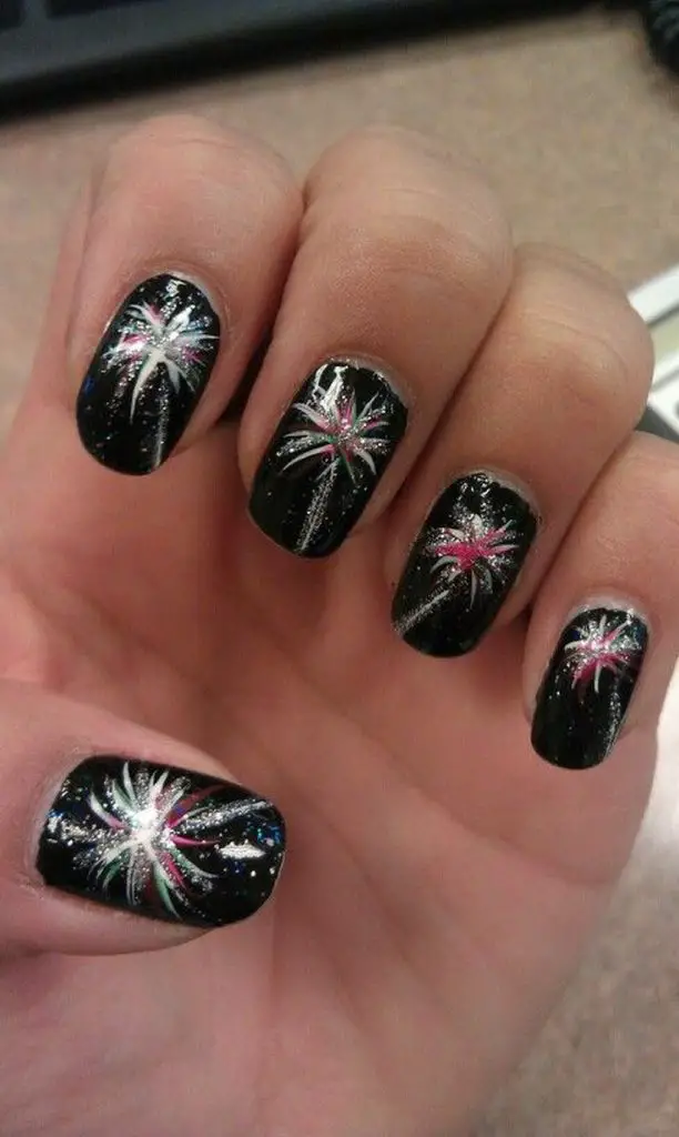 Photo of black nails with silver and pink fireworks