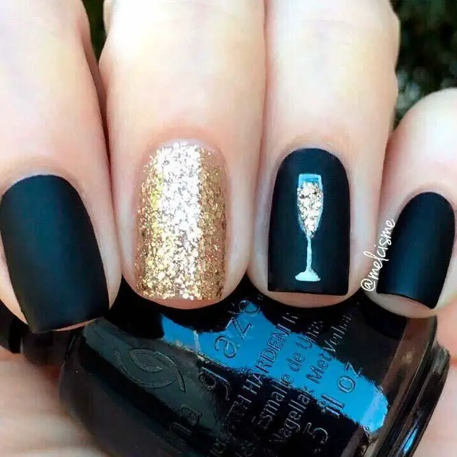 Photo of black and gold nails with accent champagne glass