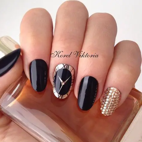Photo of black nails with clock accent and gems