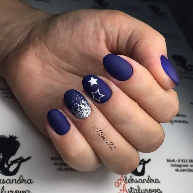 Photo of blue matte nails with stars and silver glitter